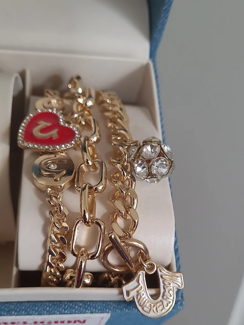 True Religion Gold-Tone Watch with Black Dial and Charm Bracelet